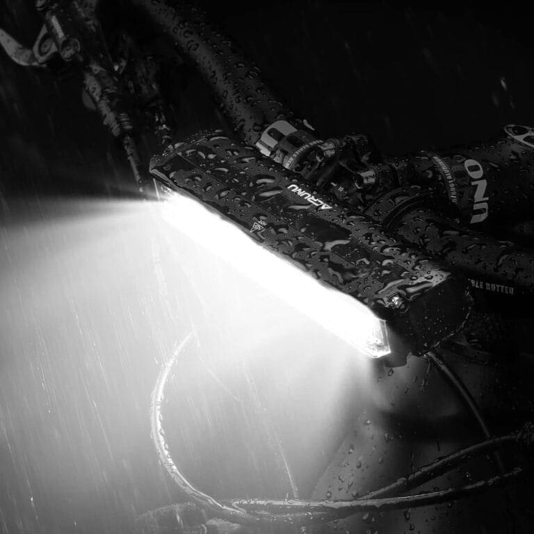 A black and white image of a bike light in the rain.