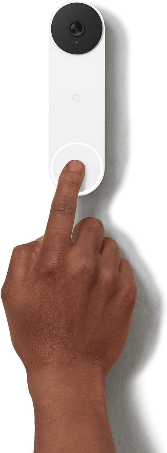 A person's hand is pointing at a google home device.